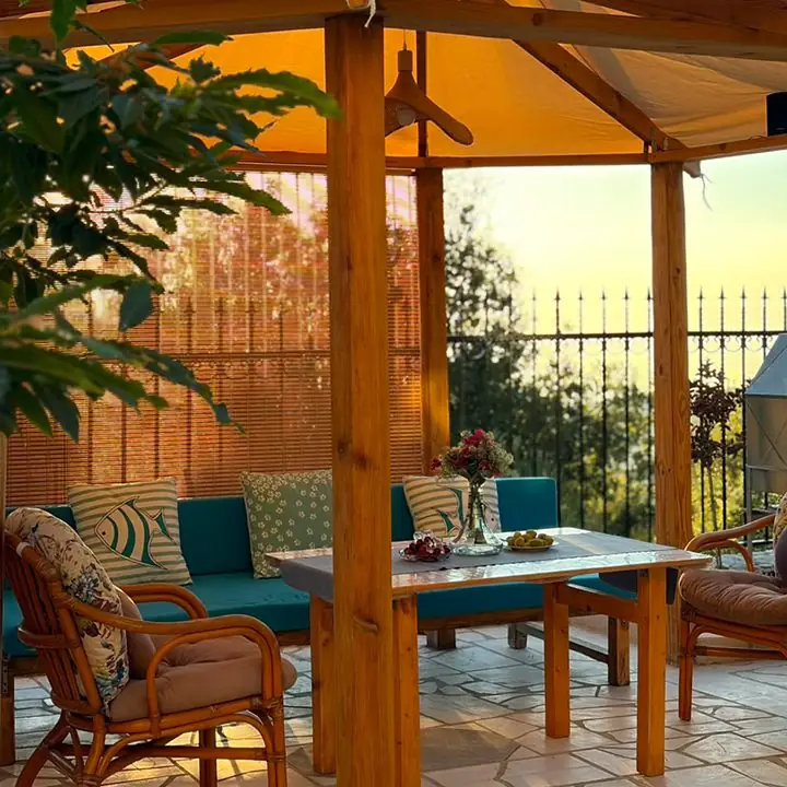 Dinner set under the pergola at dusk